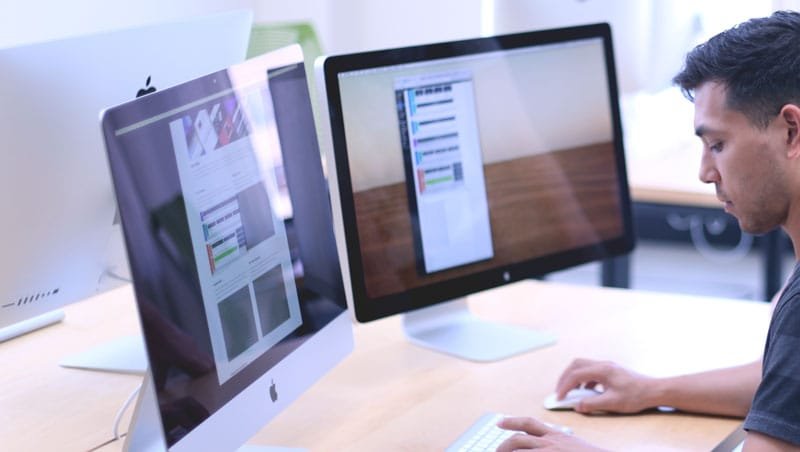 Image of man looking at screens
